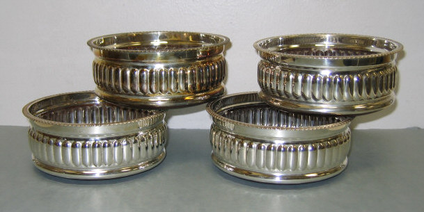 Appraisal: FOUR PLATED SILVER BOTTLE COASTERS Circular with lobed bodies gadroon