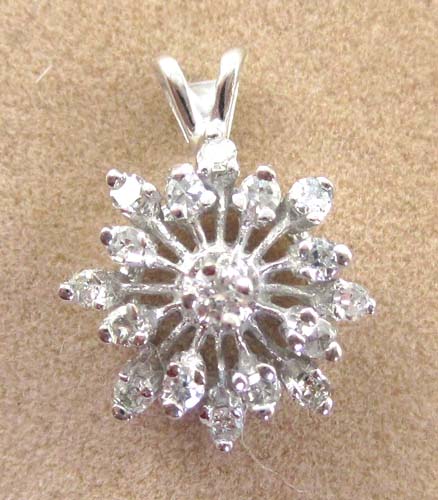 Appraisal: DIAMOND AND FOURTEEN KARAT GOLD PENDANT The white gold snowflake