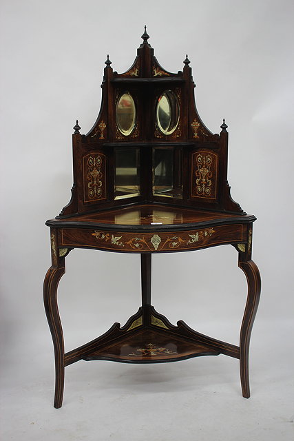 Appraisal: AN EDWARDIAN ROSEWOOD MIRROR BACKED CORNER DISPLAY TABLE with satinwood