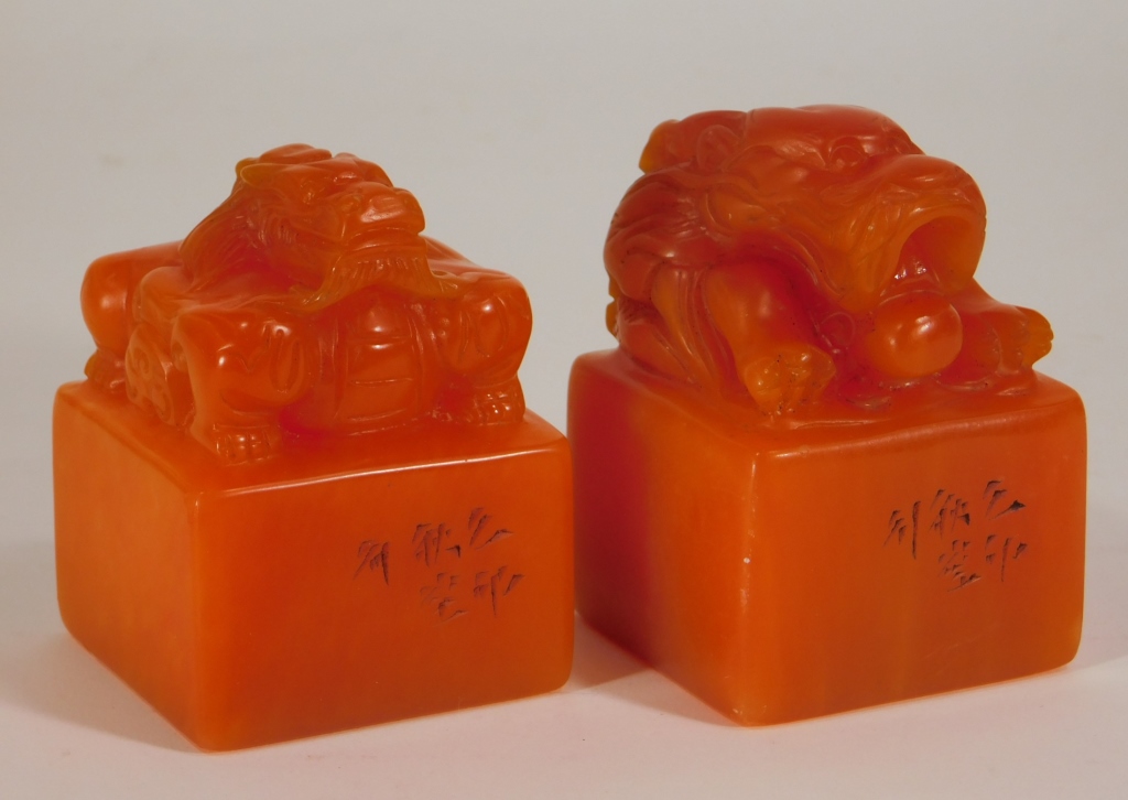 Appraisal: CHINESE CARVED ORANGE SOAPSTONE DRAGON SEALS China Early th CenturyOrange