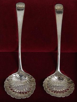 Appraisal: PAIR OF GEORGE III ARMORIAL SILVER SHELL LADLES Maker's mark