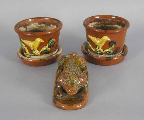 Appraisal: Two Breininger redware flower pots h together with a figure