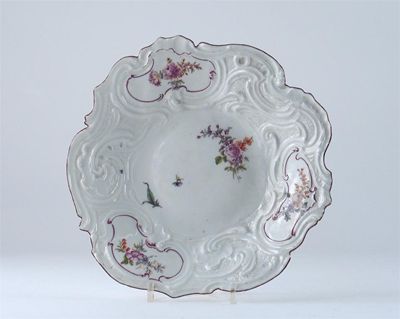 Appraisal: A Chelsea rococo moulded plate painted with panels of flowers