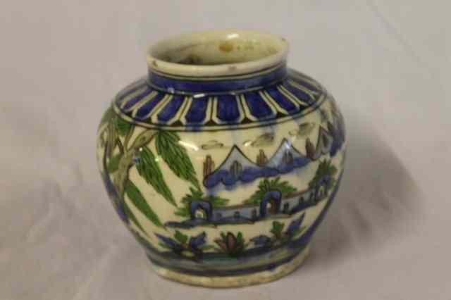 Appraisal: AN IZNIK POLYCHROME VASE depicting a girl holding a cup