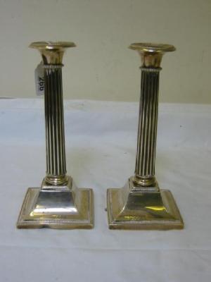 Appraisal: A PAIR OF CANDLESTICKS of columnar form with beaded edging