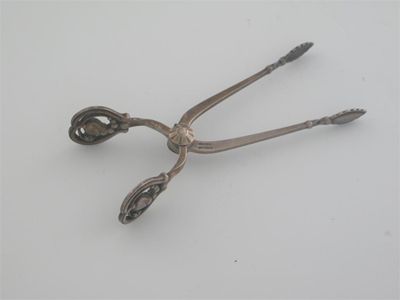 Appraisal: By Georg Jensen a pair of modern Danish sugar nips