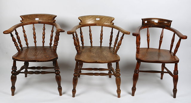 Appraisal: THREE TH CENTURY ASH AND ELM CAPTAINS CHAIRS with bobbin