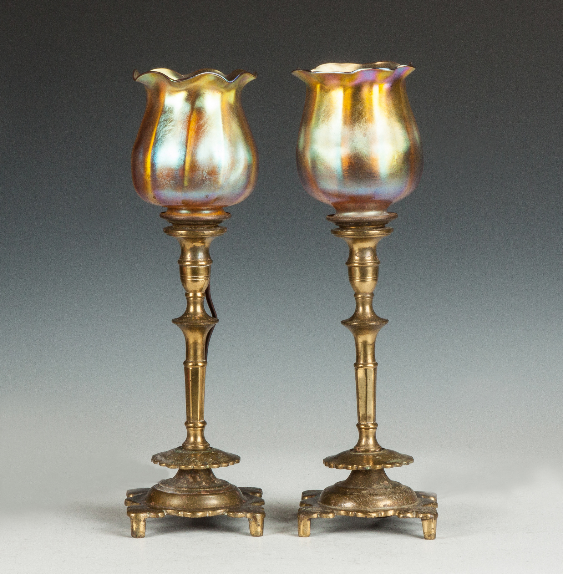 Appraisal: A Pair of Candle Lamps with Tiffany Shades Gold iridescent