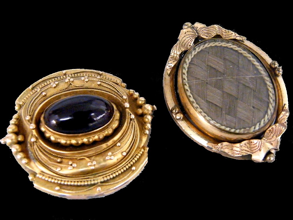 Appraisal: Victorian cabouchon garnet set mourning brooch with reverse hair locket