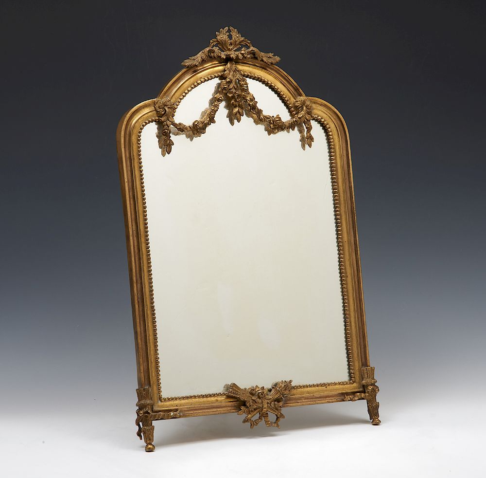 Appraisal: French brass shaped table mirror French brass shaped table mirror