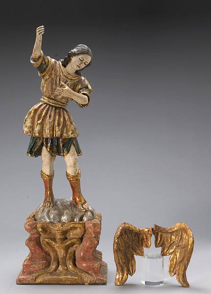 Appraisal: A Spanish Colonial carved and polychrome figure of the Archangel