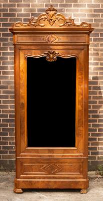 Appraisal: A late th Century walnut armoire with carved pediment enclosed