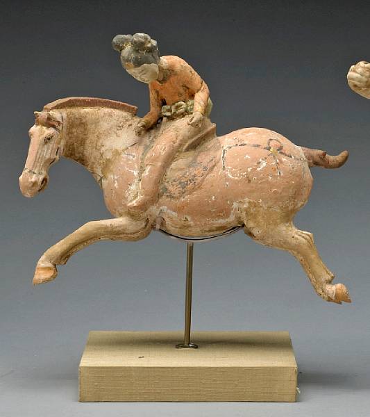 Appraisal: A painted pottery figure of a female polo player Tang