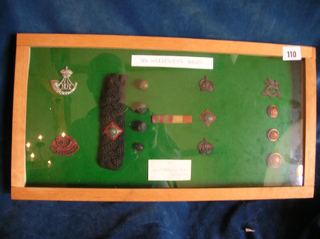 Appraisal: A display case containing a selection of Wellesley's Rifles badges