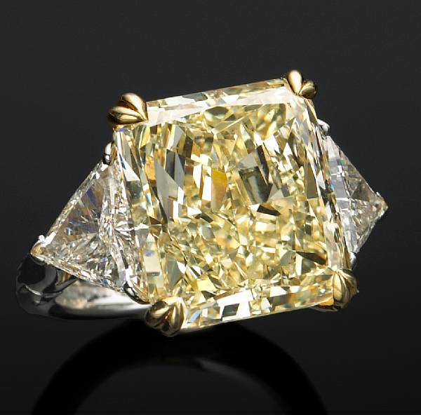 Appraisal: centering a yellow rectangular modified brilliant-cut diamond weighing carats flanked