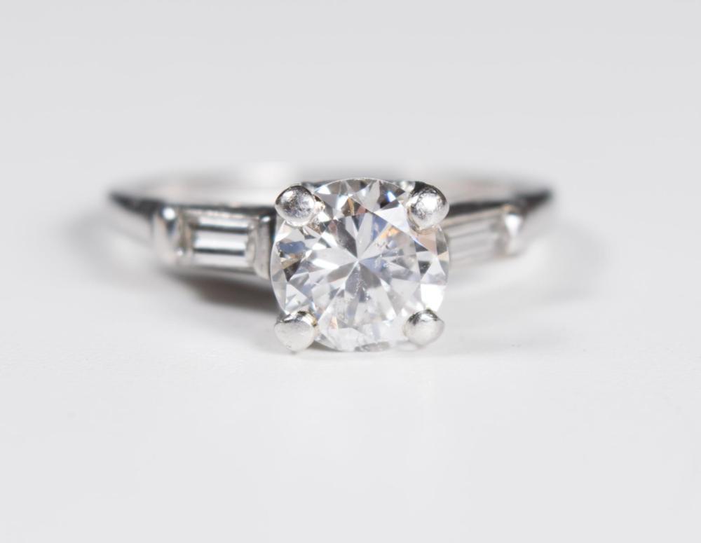 Appraisal: ESTATE DIAMOND AND PLATINUM RING with a pair of diamond