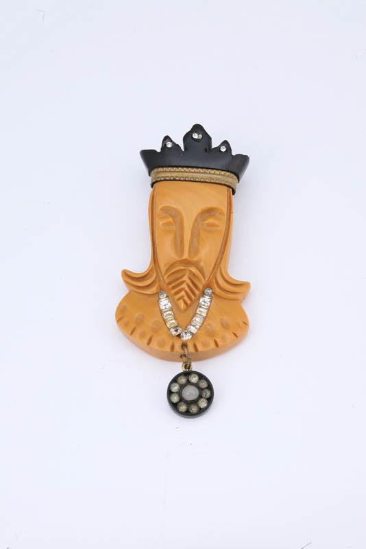 Appraisal: CARVED BAKELITE KING PIN Butterscotch carved face with a black