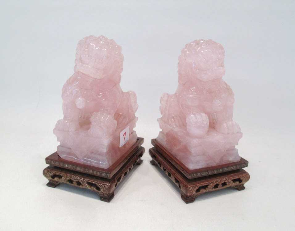 Appraisal: PAIR OF CARVED HARDSTONE FOO DOGS with conforming wood stands