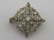 Appraisal: A white metal tests carat gold diamond brooch approx cm