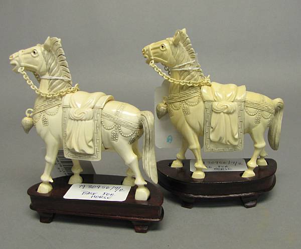 Appraisal: A pair of pieced and tinted ivory horses th Century