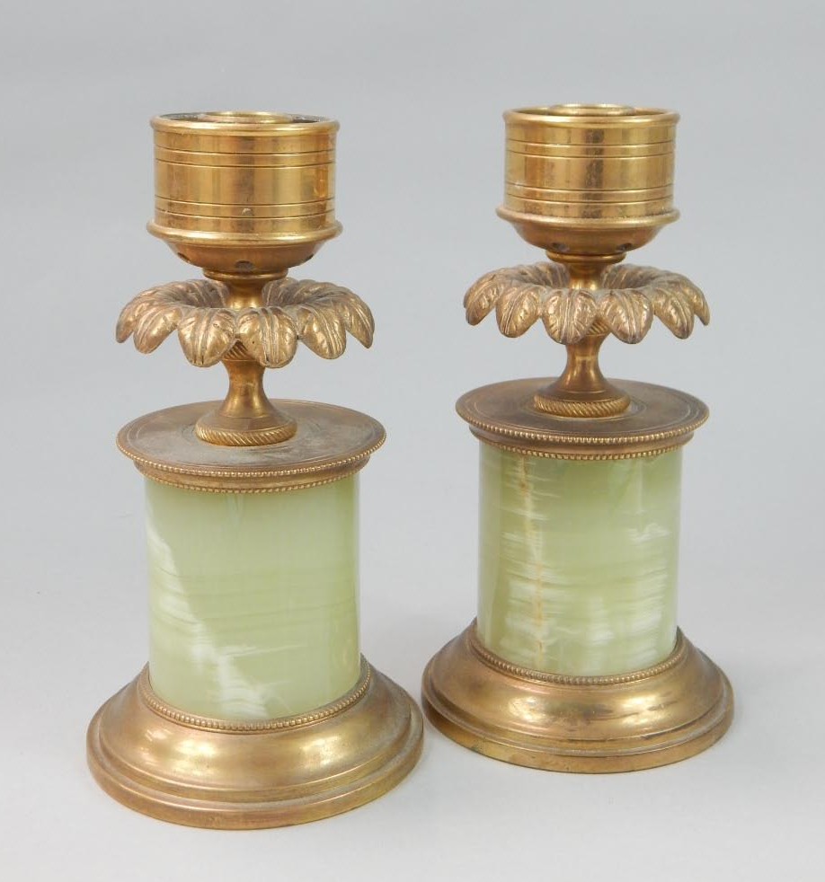 Appraisal: A pair of gilt metal candlesticks each compressed dish holder