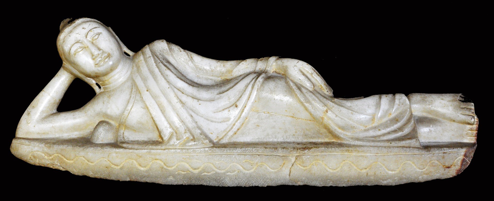 Appraisal: A Burmese alabaster figure of a reclining buddha late th