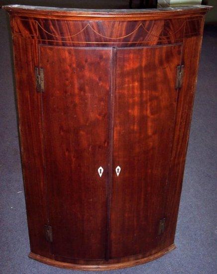 Appraisal: A George III mahogany bowfront hanging corner cupboard the pair