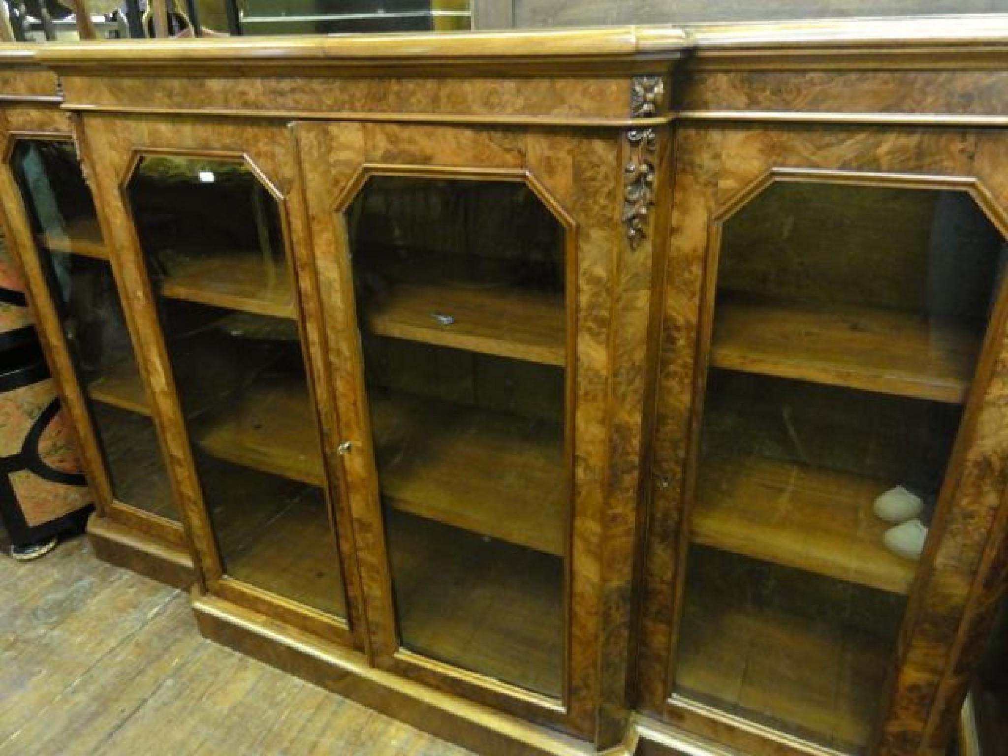 Appraisal: A Victorian walnut and figured walnut veneered breakfront side cabinet