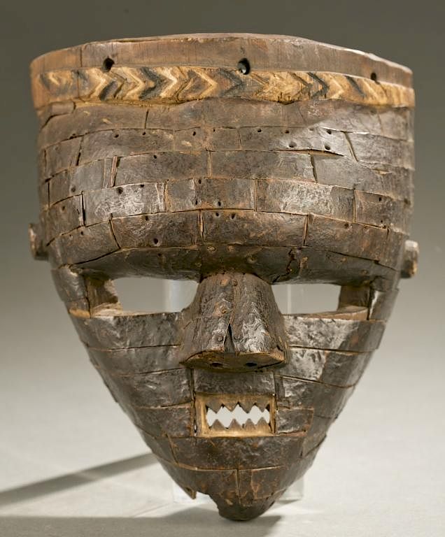 Appraisal: Salampasu wood metal mask A wooden mask embellished with metal