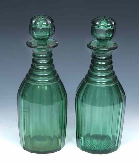 Appraisal: A PAIR OF VICTORIAN GREEN GLASS DECANTERS AND COVERS of