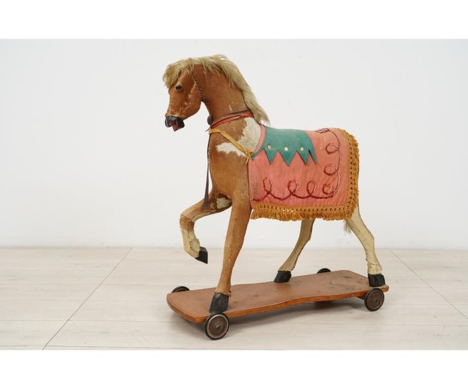 Appraisal: Child's horse pull toy circa made of hide with wood