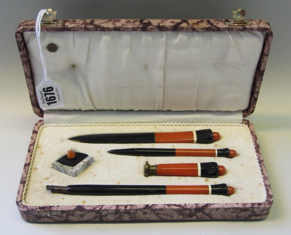 Appraisal: An Art Deco Bakelite desk set simulating red jasper and