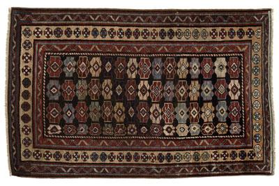 Appraisal: Kazak rug repeating rows of geometric designs on brown black