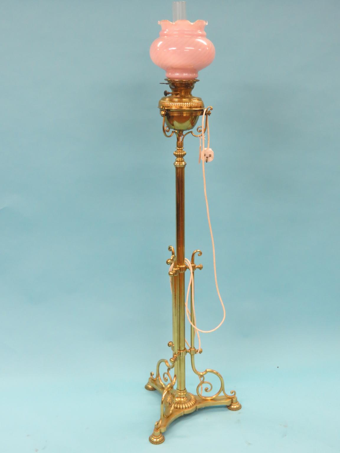 Appraisal: A Victorian telescopic brass floor lamp on tri-form scroll base