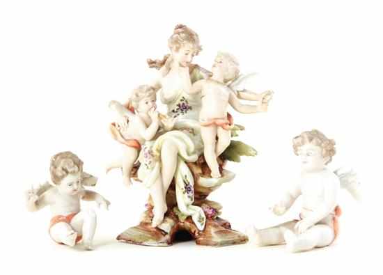 Appraisal: German porcelain figurals seated maiden flanked by cherubs H ''