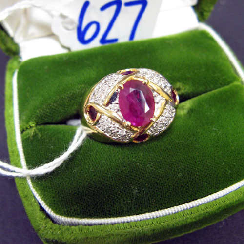 Appraisal: RUBY DIAMOND AND FOURTEEN KARAT GOLD RING centering an oval-cut