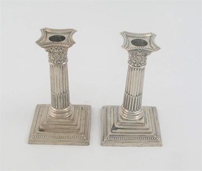 Appraisal: A pair of late Victorian dwarf Corinthian column candlesticks on