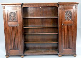 Appraisal: Large carved oak bookcase having carved doors on each side