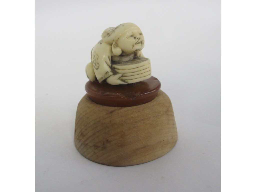 Appraisal: Netsuke - man crouching with box