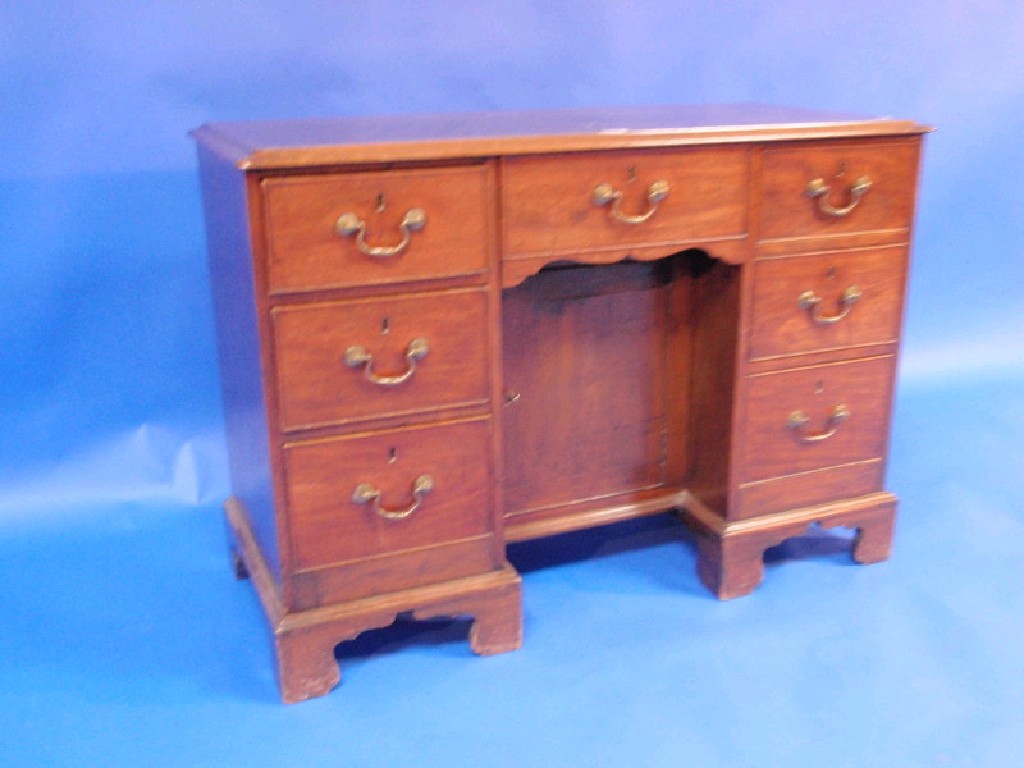 Appraisal: A Victorian mahogany kneehole desk with brass drop handles and