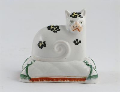 Appraisal: A Staffordshire porcelain model of a cat seated on a