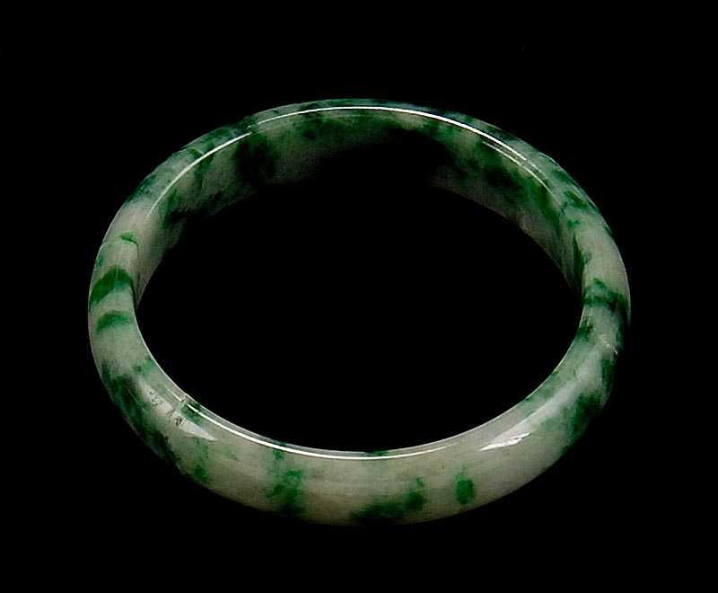 Appraisal: GREEN AND WHITE JADE BANGLE BRACELET Exterior diameter cm interior