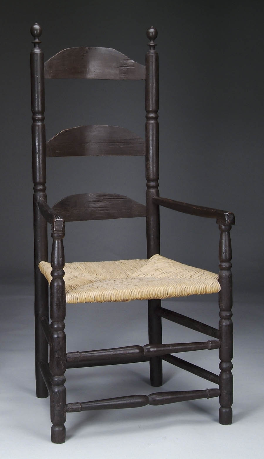 Appraisal: EARLY THREE SLAT LADDER-BACK ARMCHAIR Nicely turned elongated ball finials