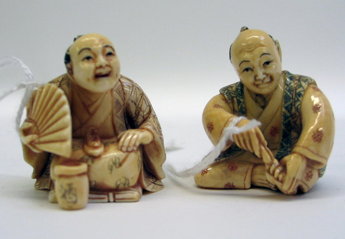 Appraisal: TWO JAPANESE CARVED IVORY NETSUKE each depicts a man in