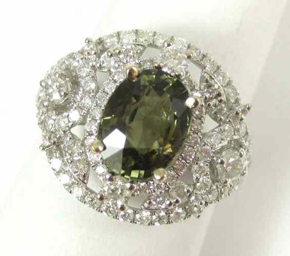 Appraisal: GREEN SAPPHIRE AND DIAMOND RING k white gold centering an