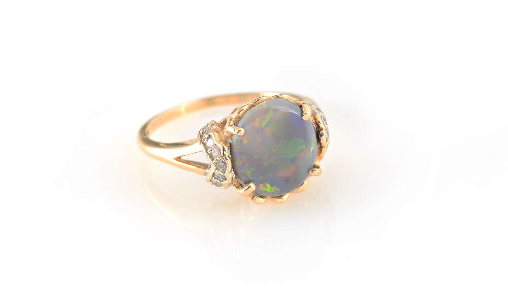 Appraisal: OPAL DIAMOND RING K yellow gold ring centering one round