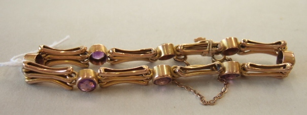 Appraisal: A gold and amethyst set gate bracelet collet set with