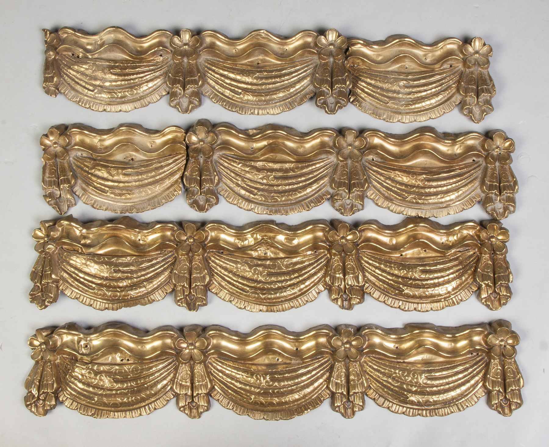 Appraisal: Eight Stamped Brass Valences Early th cent Swag bow design