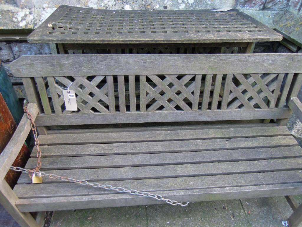 Appraisal: A pair of weathered teakwood garden benches with decorative lattice