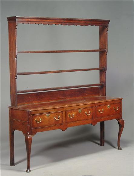 Appraisal: A George III oak dresser circa the shaped frieze above